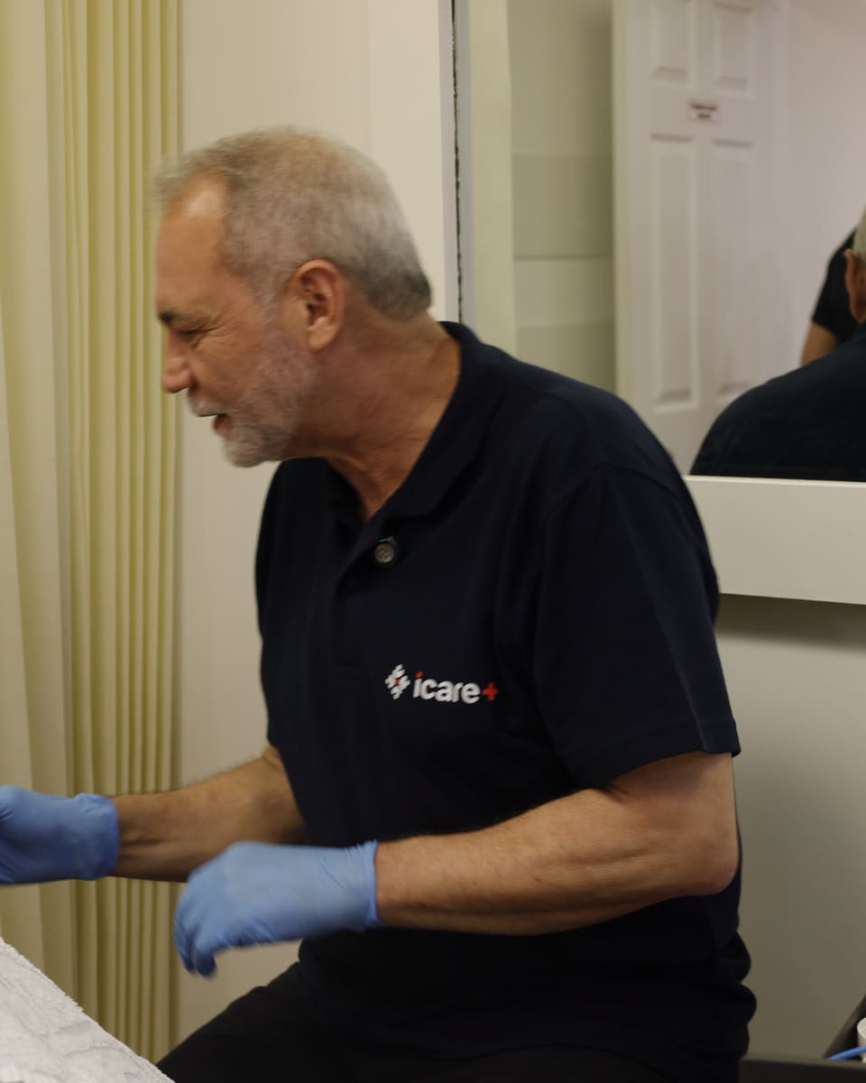 Romualdo Marcílio preparing for a treatment session in the PRC Clinic treatment room.