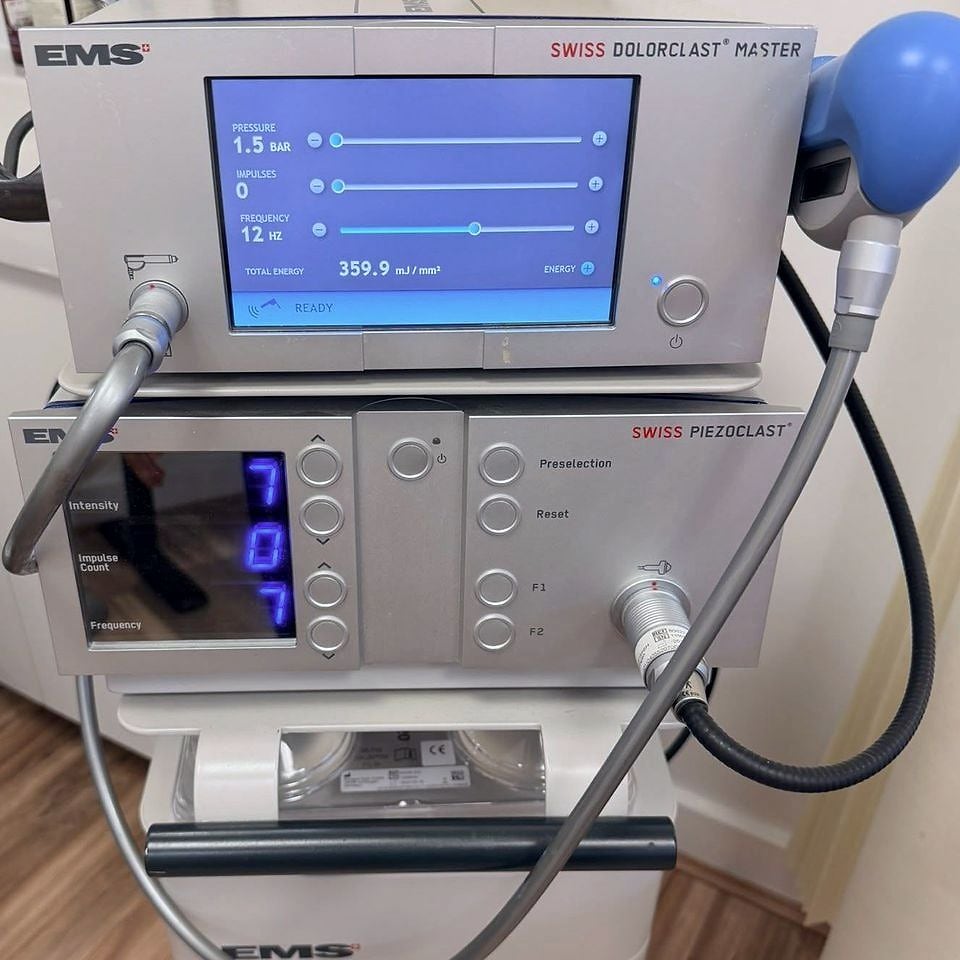The EMS Swiss Piezoclast focused shockwave unit beneath the Swiss Dolorclast Master at PRC Clinic.
